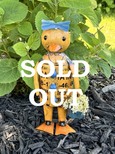 ELLA DUCK HOLDING A BLUE BUCKET